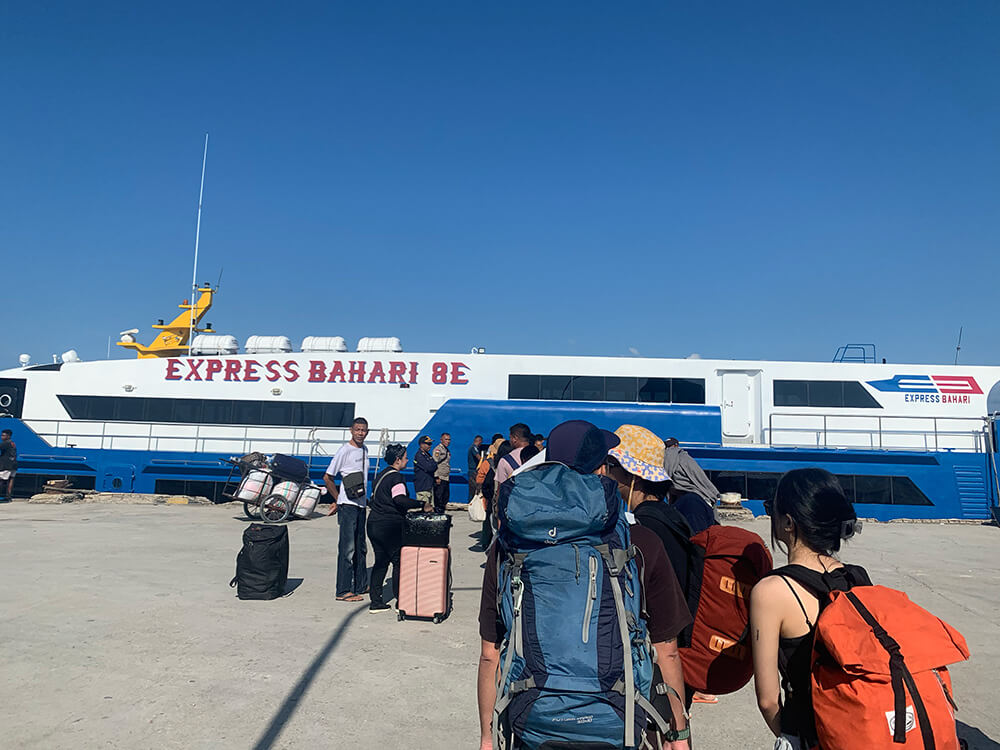 Travelers line up to board the Express Bahari fast ferry 8E to Rote Island Indonesia