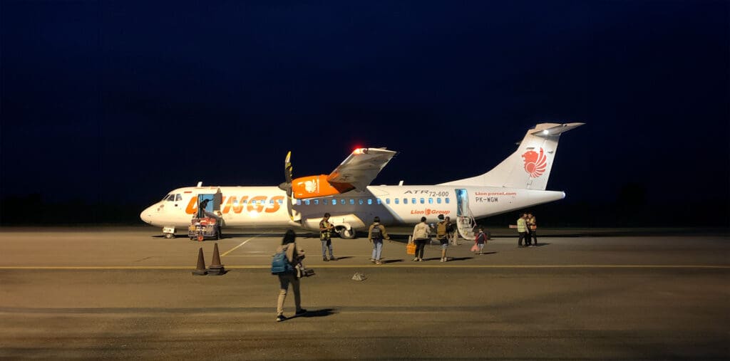 Wings Air ATR Aircraft on the tarmac at Rote Island Airport at night.